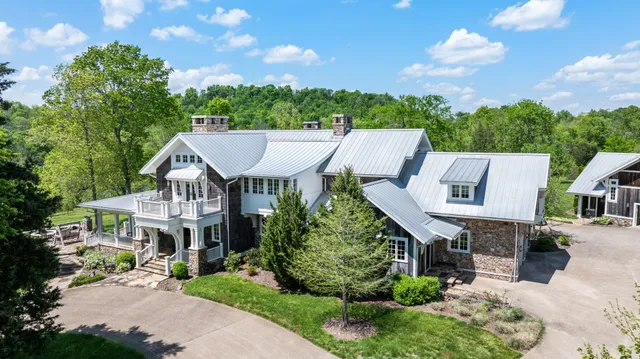 a front view of a house with a garden and a yard