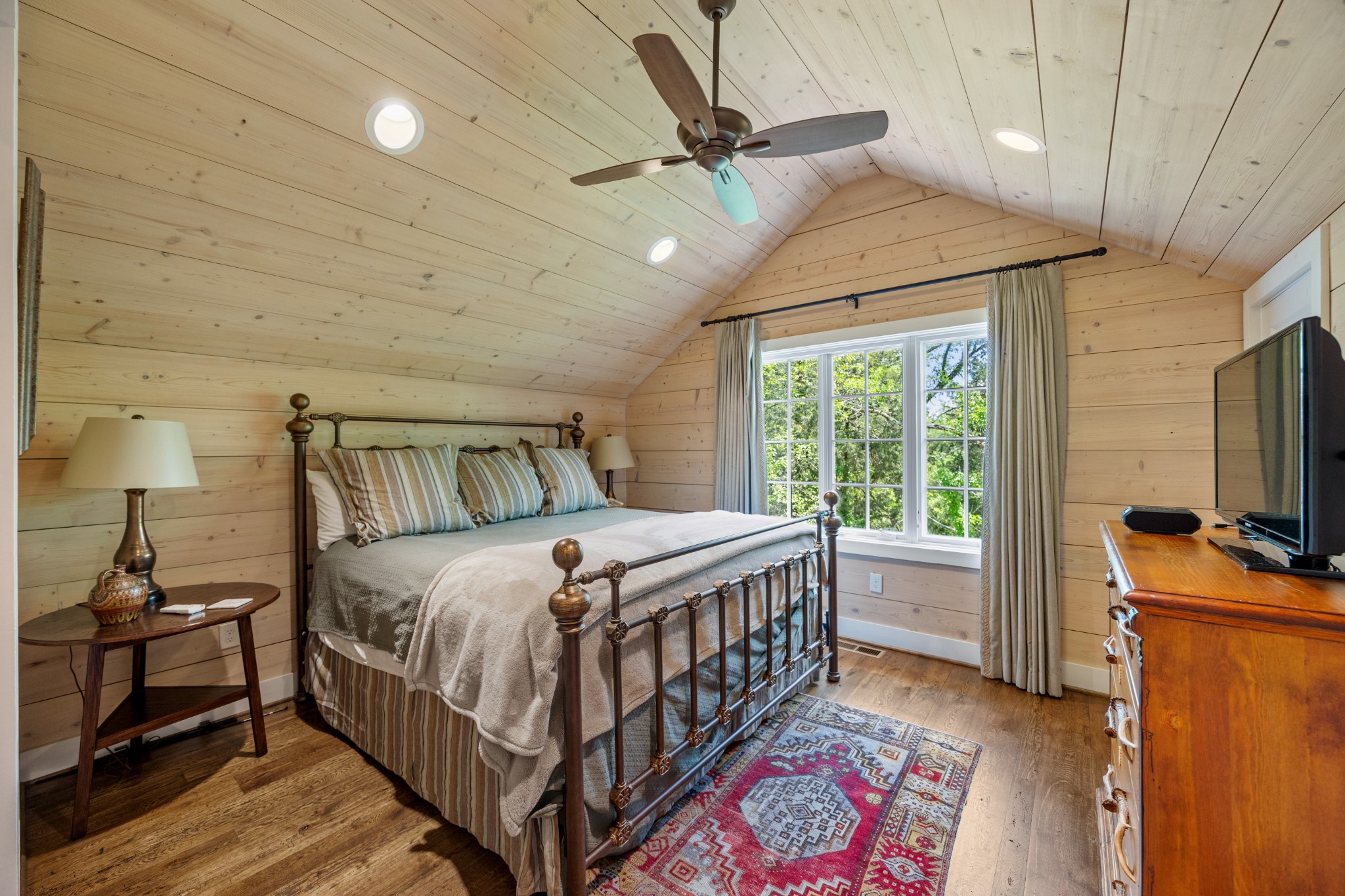 605 Red Oak Road Petersburg, TN 37144 - Photo 77 of 98 a bedroom with a bed a flat screen tv and a chandelier