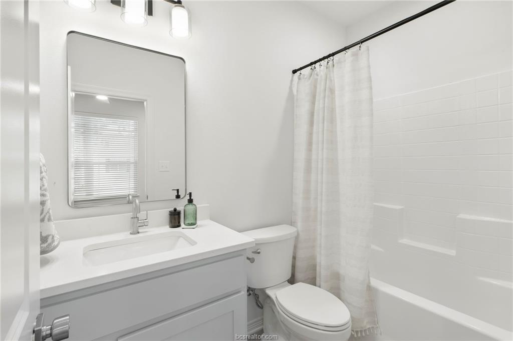 307 Sterling Street, Unit D College Station, TX 77840 - Photo 9 of 18 a bathroom with a sink a toilet and shower