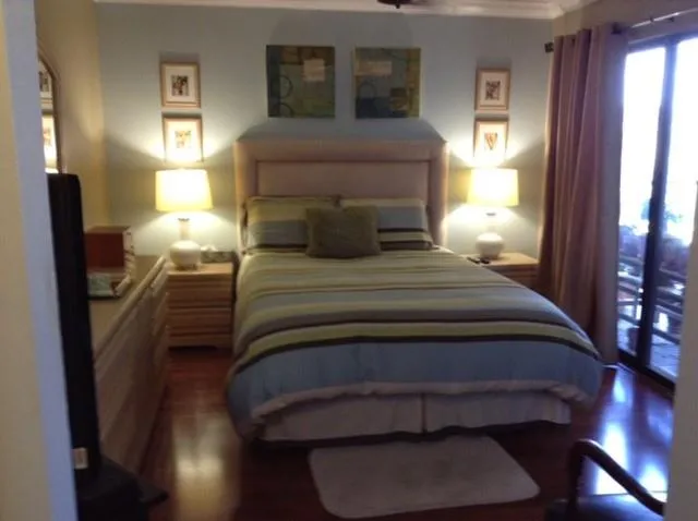 a bedroom with a bed and a night stand