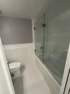 a bathroom with a shower and toilet