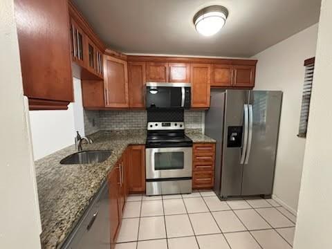 3199 Foxcroft Road, Unit 308 Miramar, FL 33025 - Photo 9 of 9 a kitchen with granite countertop a refrigerator and a stove