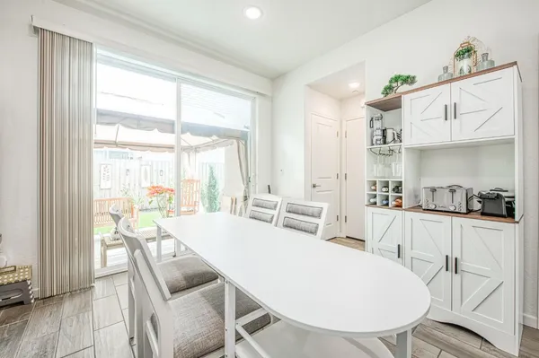 a view of a dining room with furniture wooden floor and kitchen view