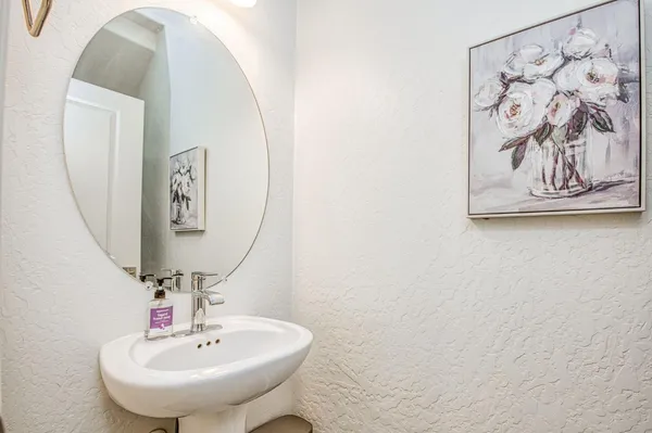 a bathroom with a sink and mirror
