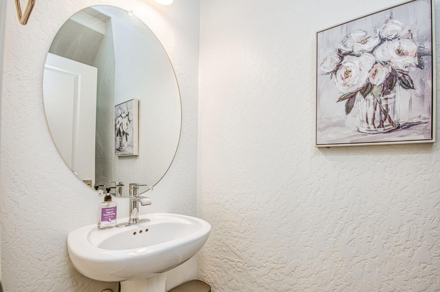 2053 North Ralph Lane Clovis, CA 93619 - Photo 16 of 31 a bathroom with a sink and mirror