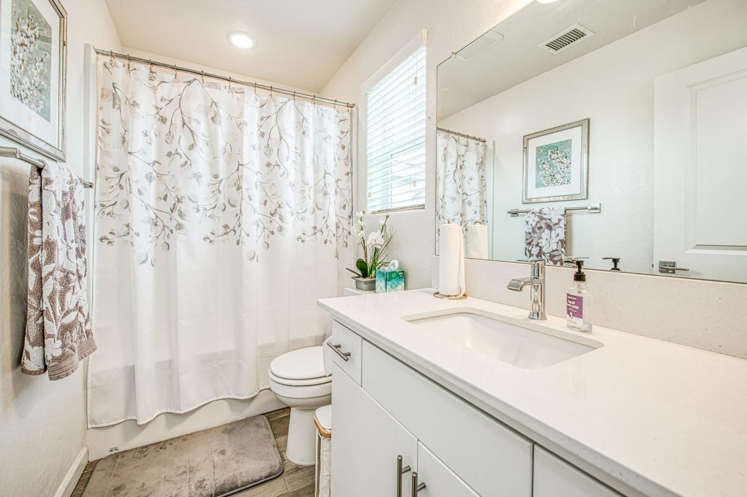 2053 North Ralph Lane Clovis, CA 93619 - Photo 20 of 31 a bathroom with a sink and a mirror