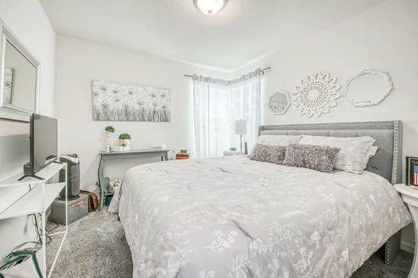 a bedroom with a bed and a table