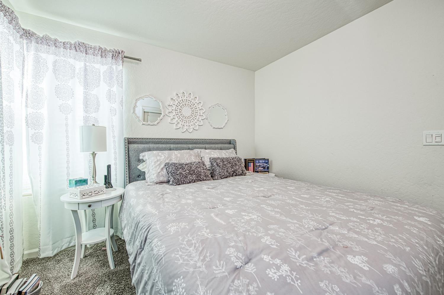 2053 North Ralph Lane Clovis, CA 93619 - Photo 22 of 31 a bedroom with a bed and a table