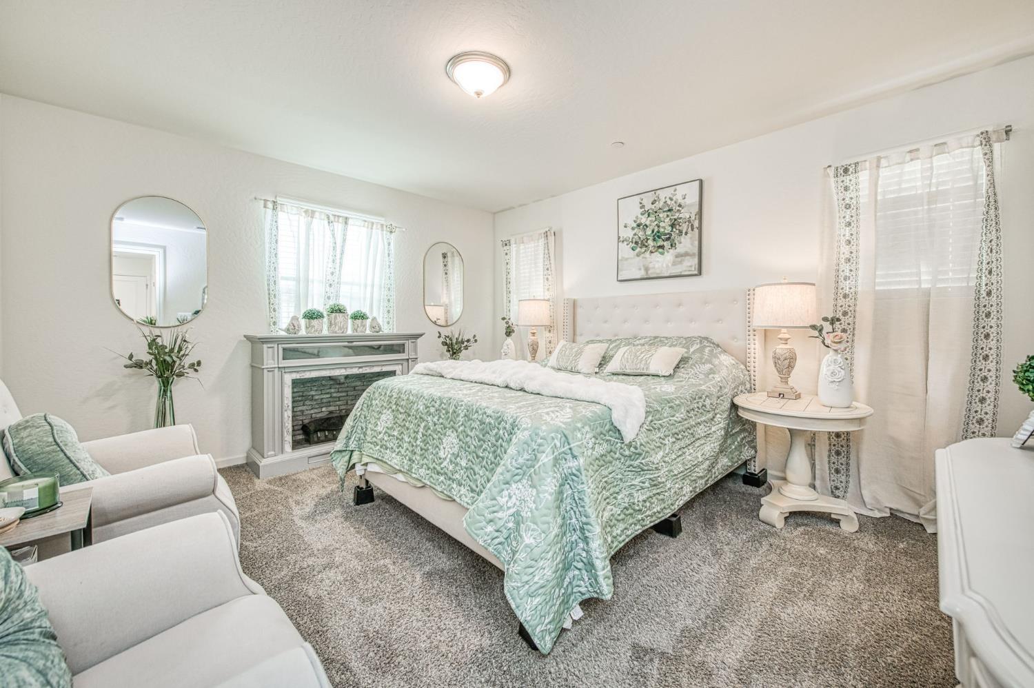 2053 North Ralph Lane Clovis, CA 93619 - Photo 23 of 31 a spacious bedroom with a bed a couch and dresser