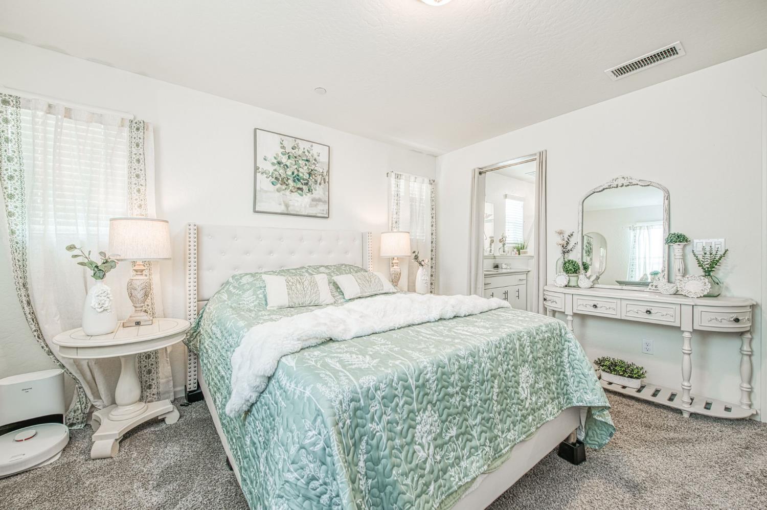 2053 North Ralph Lane Clovis, CA 93619 - Photo 24 of 31 a spacious bedroom with a bed a table and chair