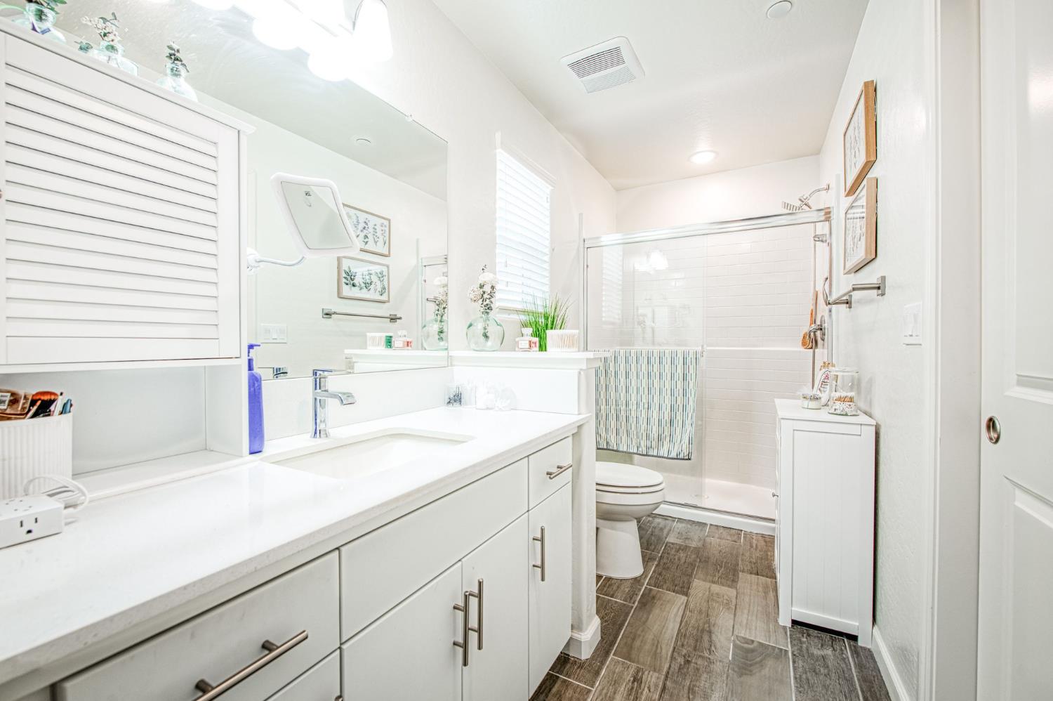 2053 North Ralph Lane Clovis, CA 93619 - Photo 25 of 31 a bathroom with a sink a toilet and a shower