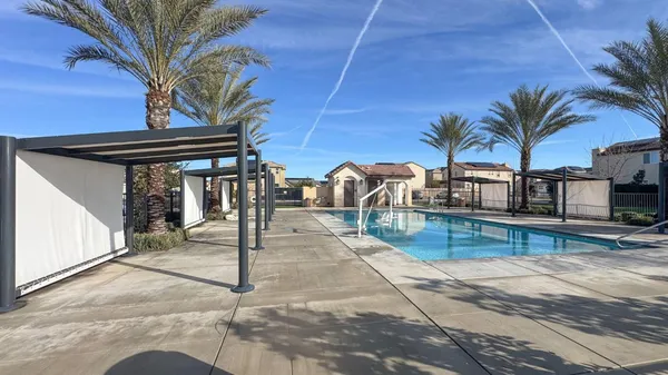 a view of a backyard patio and swimming pool