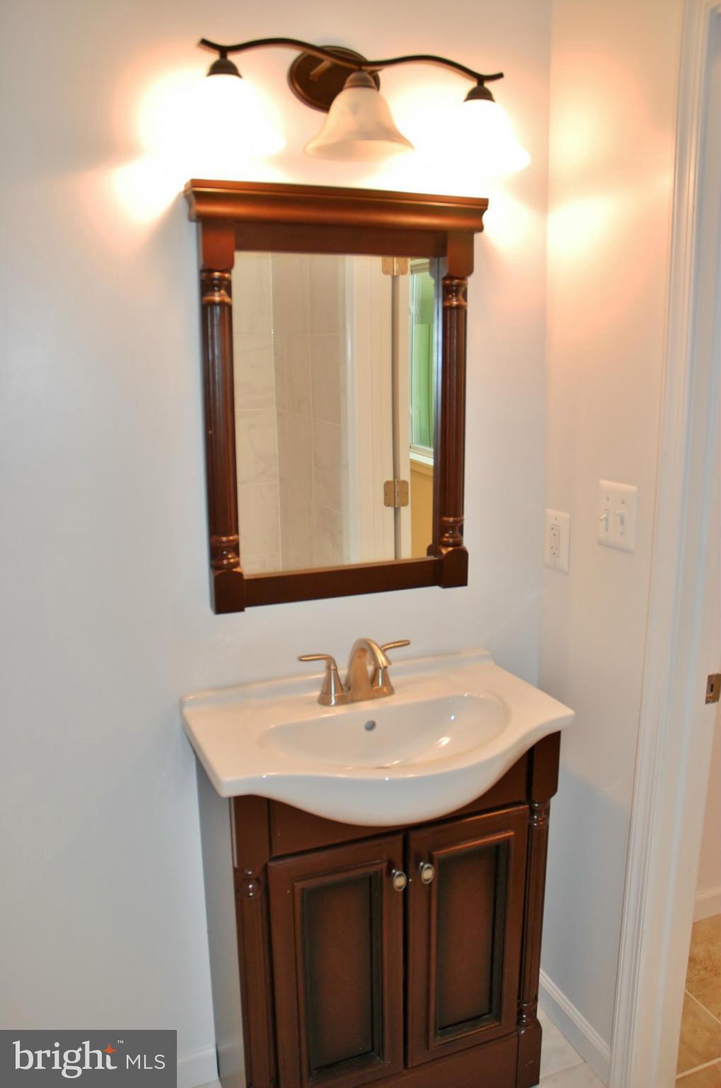 211 Thistle Drive Silver Spring, MD 20901 - Photo 14 of 23 a bathroom with a sink and a mirror