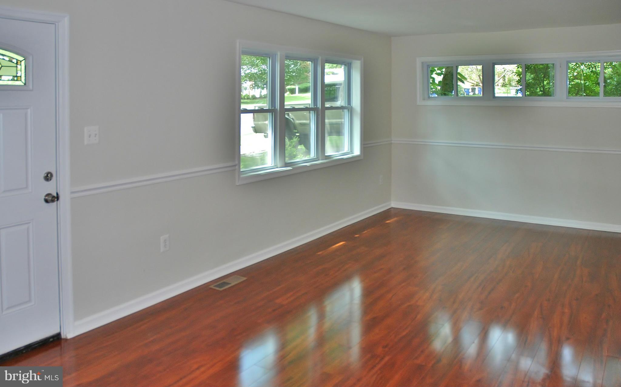 211 Thistle Drive Silver Spring, MD 20901 - Photo 2 of 23 an empty room with wooden floor and windows