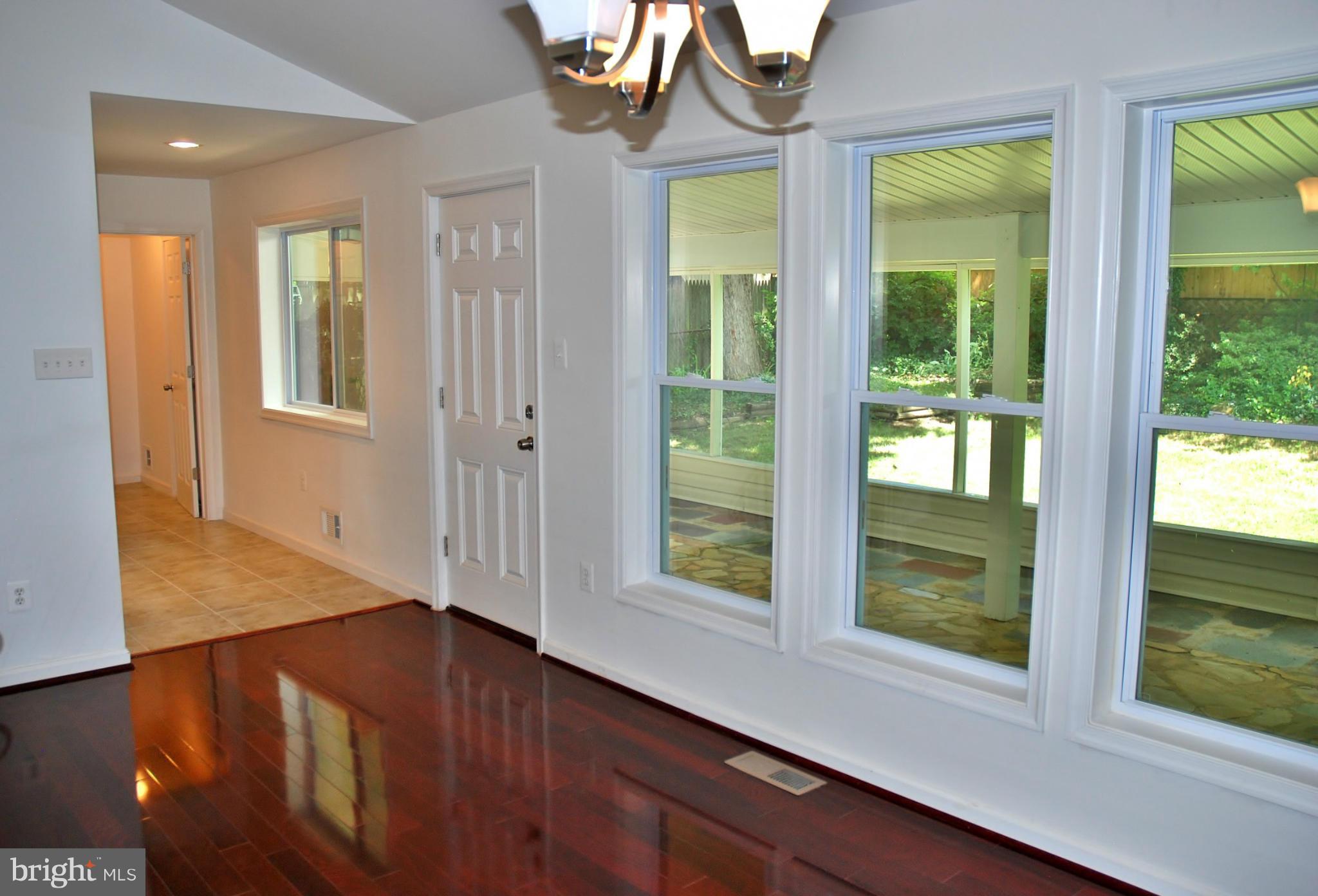 211 Thistle Drive Silver Spring, MD 20901 - Photo 4 of 23 a view of an entryway with wooden floor and door