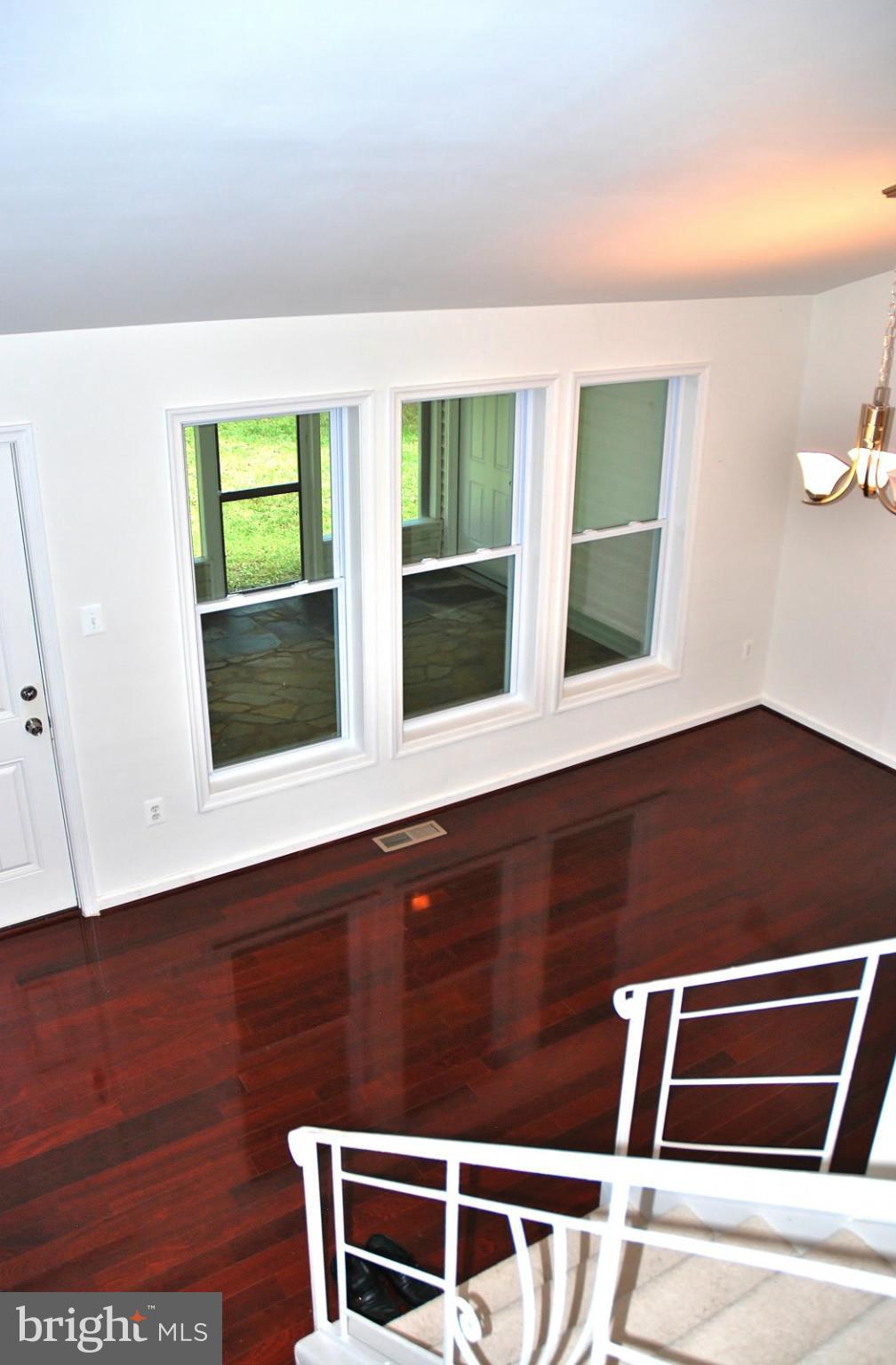 211 Thistle Drive Silver Spring, MD 20901 - Photo 5 of 23 a view of an empty room with wooden floor