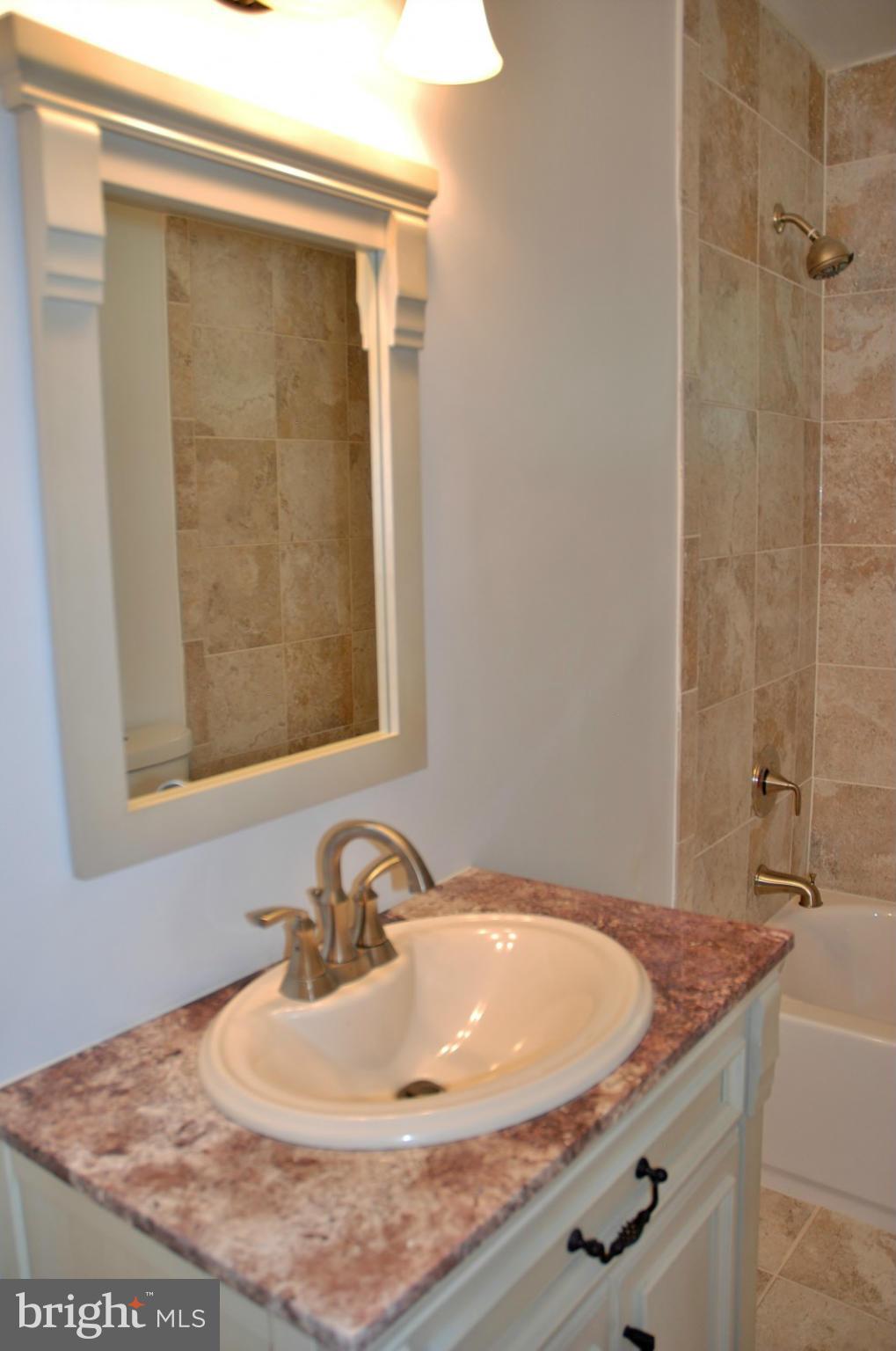 211 Thistle Drive Silver Spring, MD 20901 - Photo 8 of 23 a bathroom with a granite countertop sink and a mirror