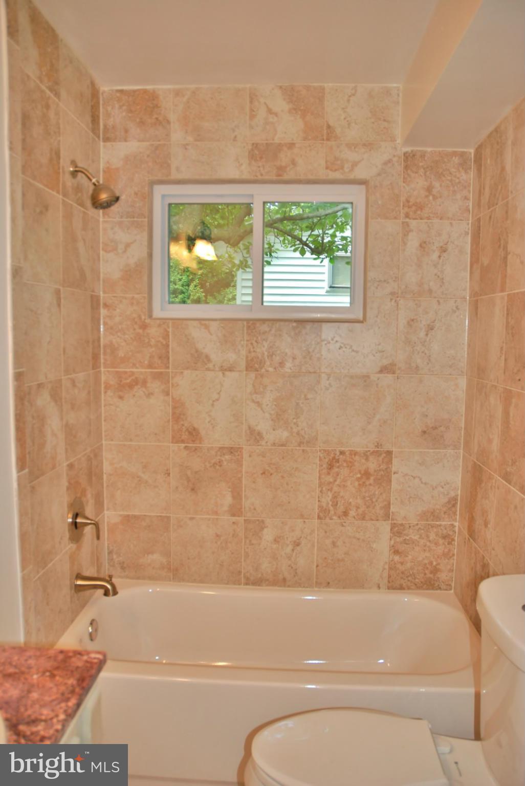 211 Thistle Drive Silver Spring, MD 20901 - Photo 9 of 23 a bathroom with a bathtub and a shower