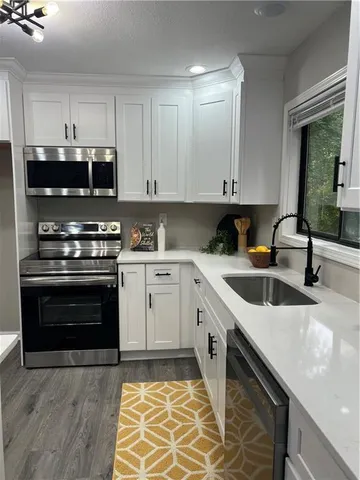 a kitchen with a stove cabinets and counter space