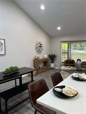 a kitchen with a sink a stove and chairs with wooden floor