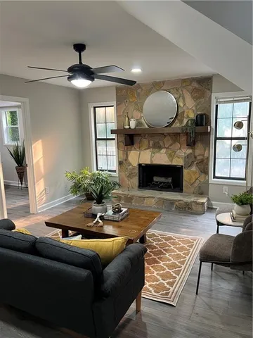 a living room with furniture and wooden floor