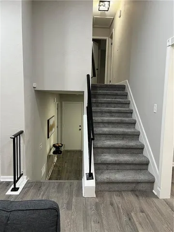 a bedroom with a bed painting on wall and a large window