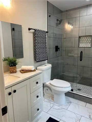 a bathroom with a toilet and a shower