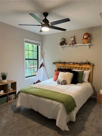 a bed sitting in a bedroom next to a window