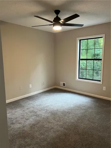 a view of a room with a table and chairs