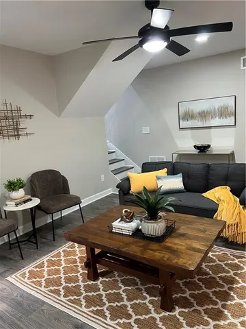 a view of a room with furniture and wooden floor