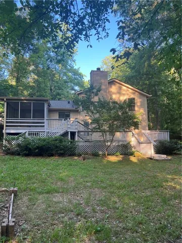 a living room with fireplace furniture and a large window