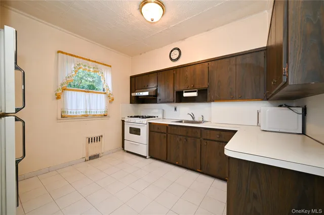 a kitchen with stainless steel appliances granite countertop a sink and a stove