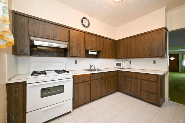 a kitchen with a sink a stove and cabinets