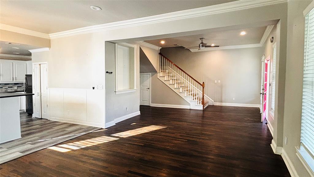 4511 Junius Street Dallas, TX 75246 - Photo 2 of 16 Open concept living area with dark wood-flooring and crown molding