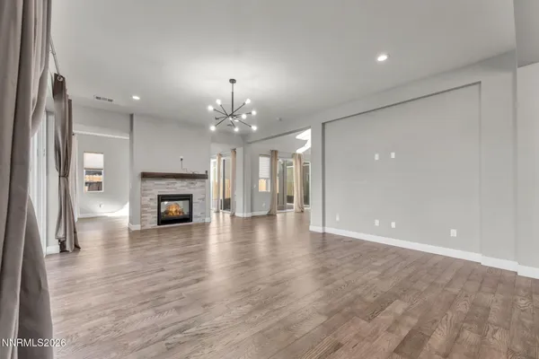 a view of kitchen view wooden floors appliances and cabinets