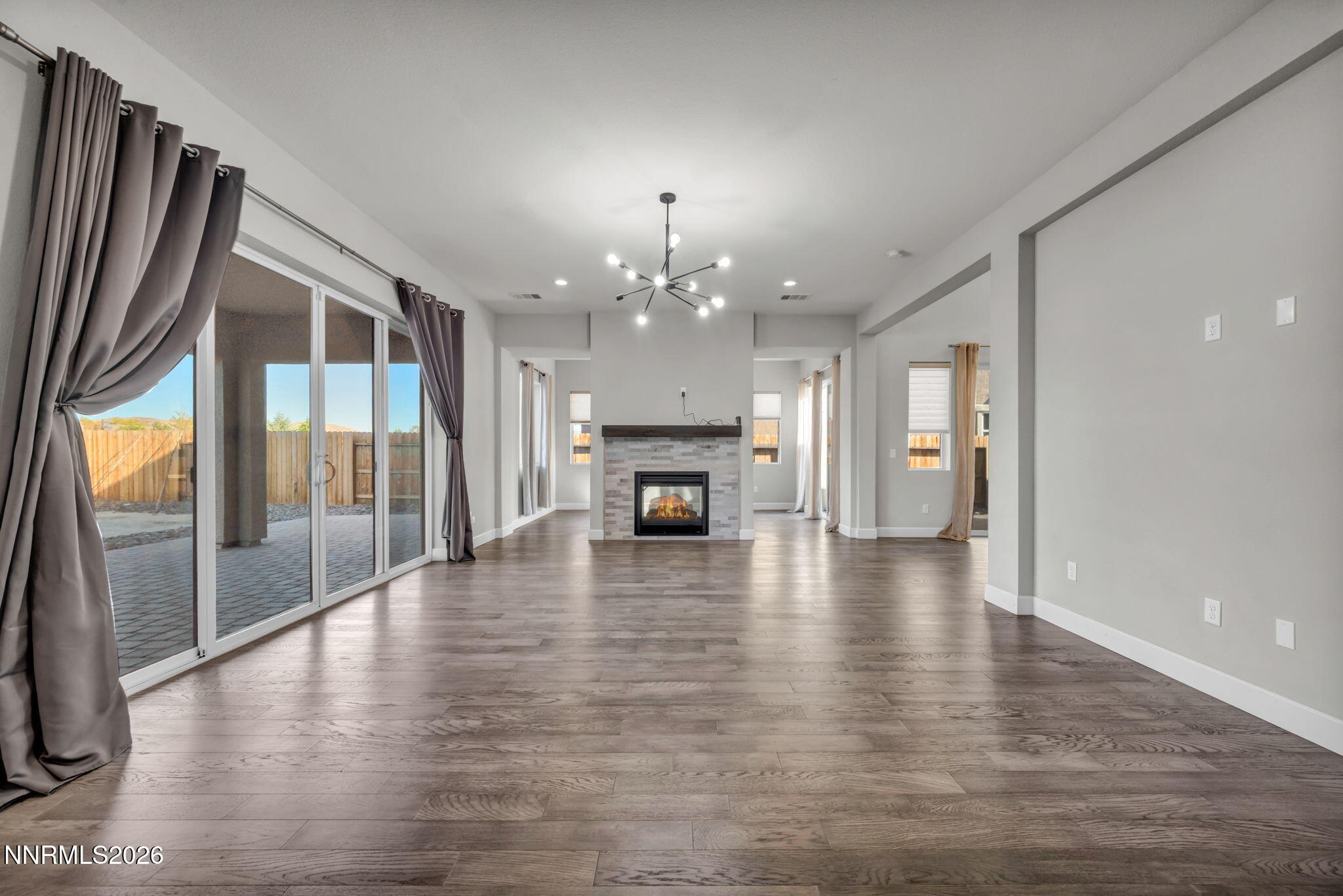 9267 Blue Basin Trail Reno, NV 89521 - Photo 13 of 95 a view of a livingroom with a fireplace wooden floor and chandelier