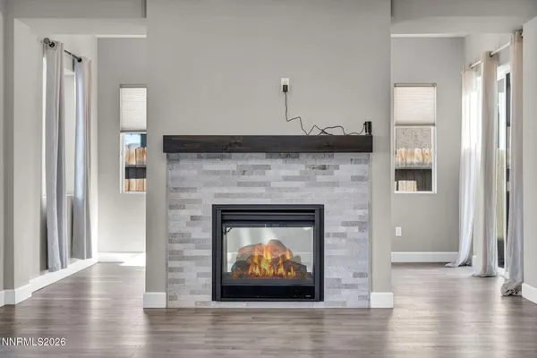 a large kitchen with stainless steel appliances granite countertop a large counter top a stove and a wooden floors