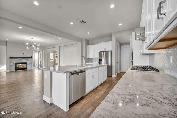 a kitchen with stainless steel appliances granite countertop a sink stove and cabinets