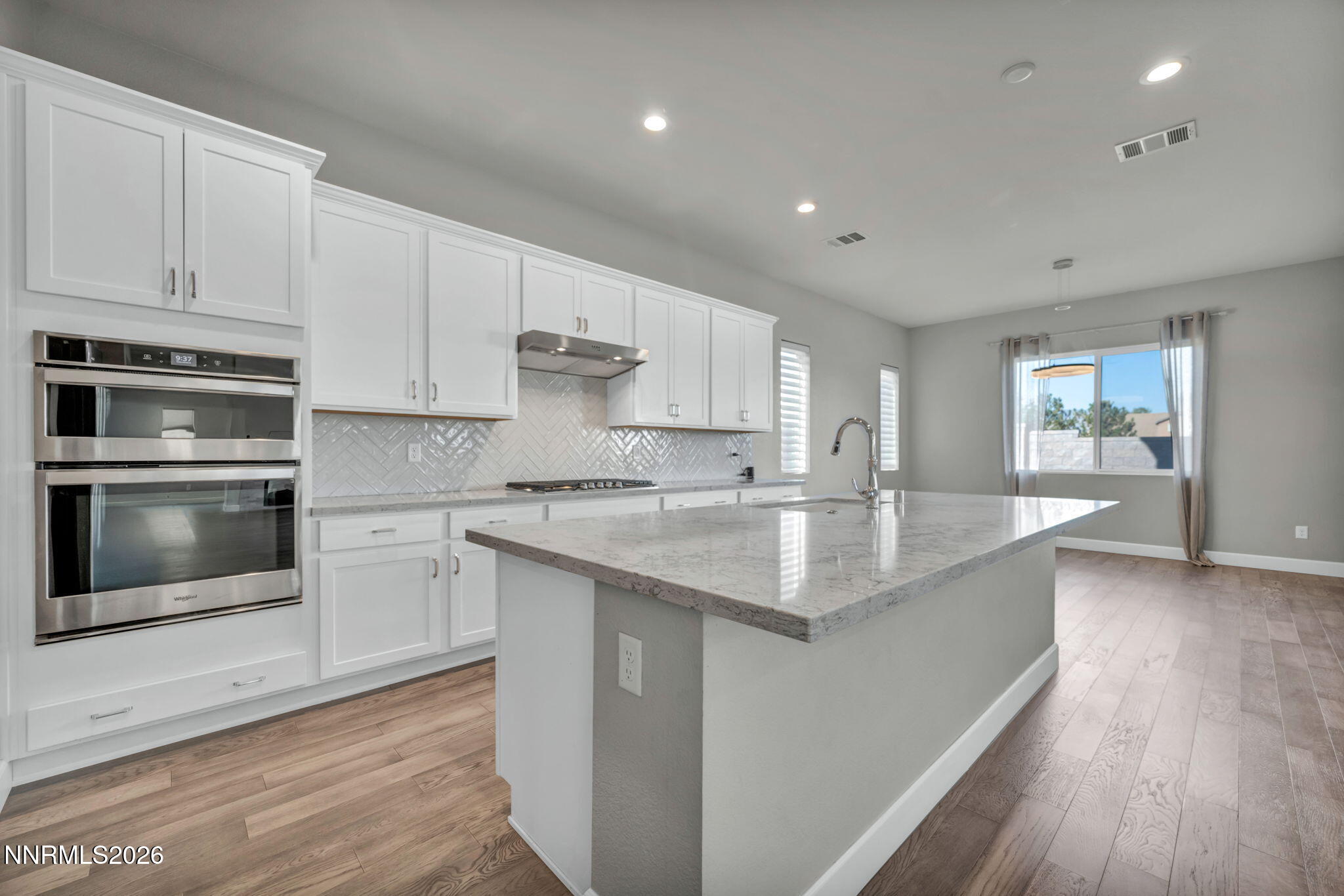 9267 Blue Basin Trail Reno, NV 89521 - Photo 22 of 95 a kitchen with stainless steel appliances granite countertop a sink stove and cabinets