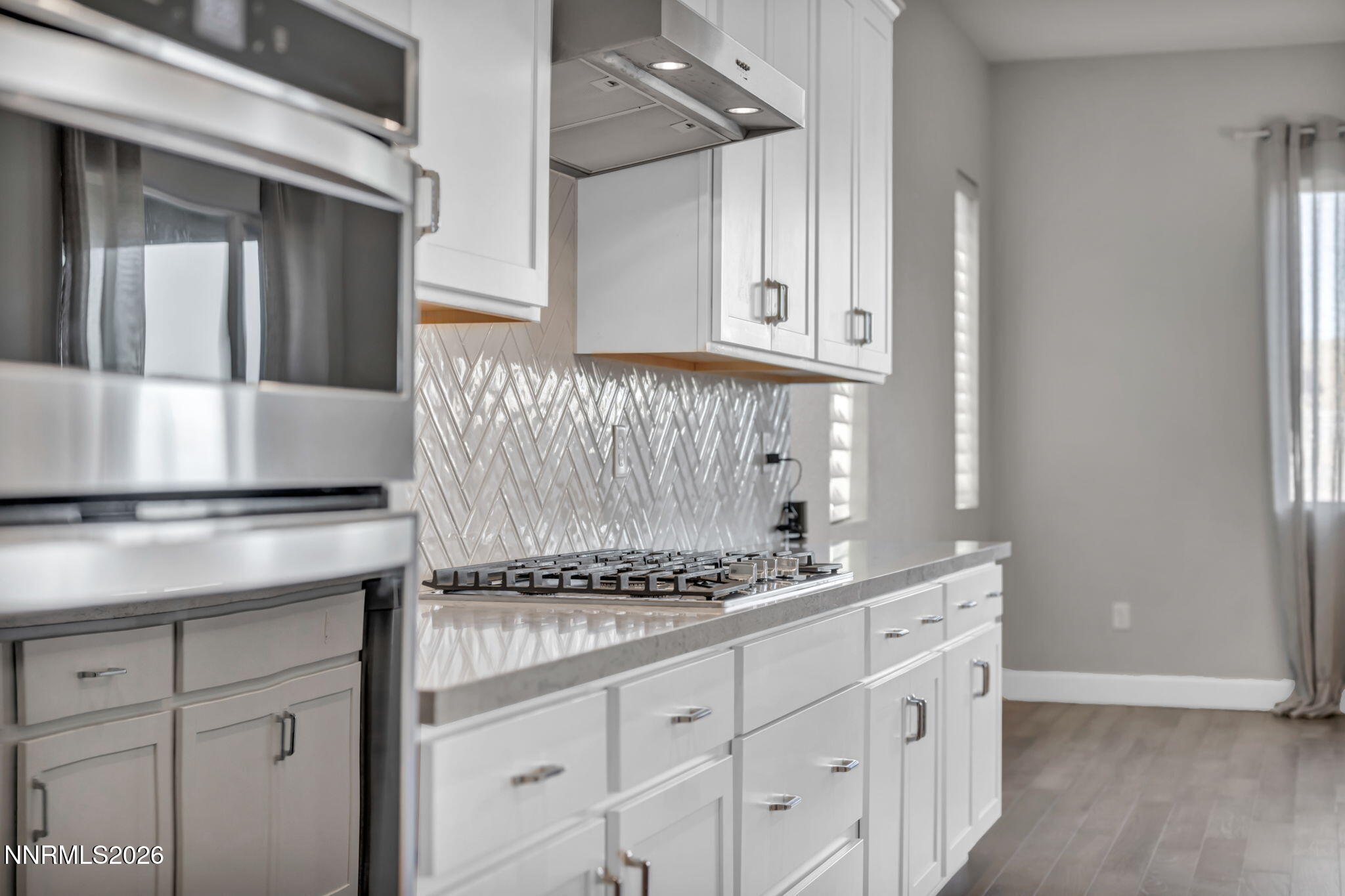 9267 Blue Basin Trail Reno, NV 89521 - Photo 23 of 95 a kitchen with granite countertop a sink cabinets and stainless steel appliances
