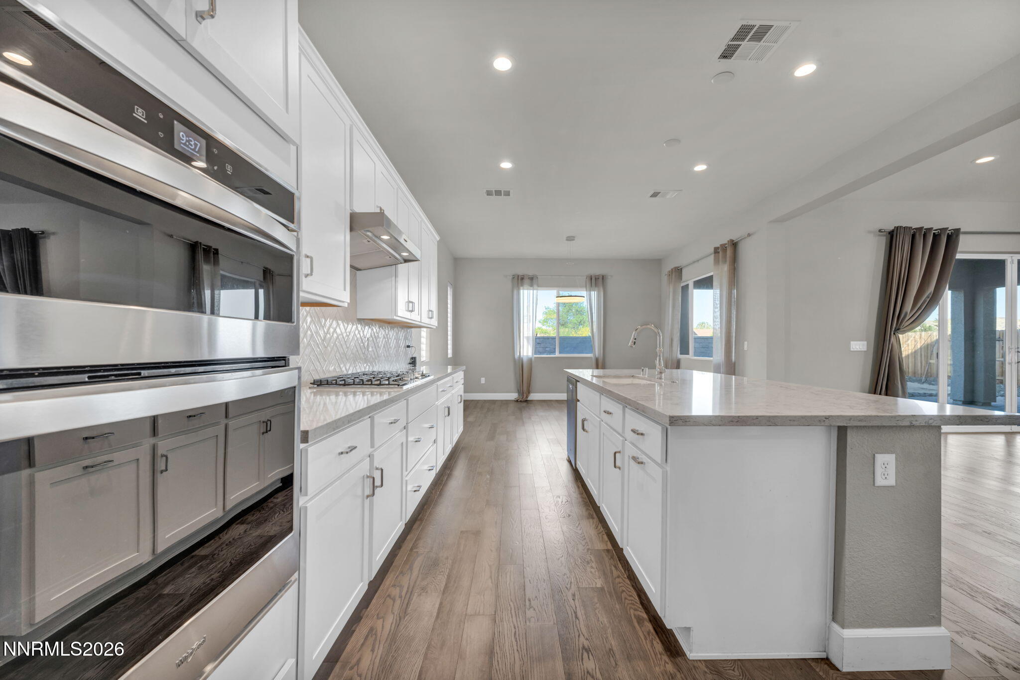 9267 Blue Basin Trail Reno, NV 89521 - Photo 27 of 95 a large kitchen with stainless steel appliances lots of counter space and wooden floor