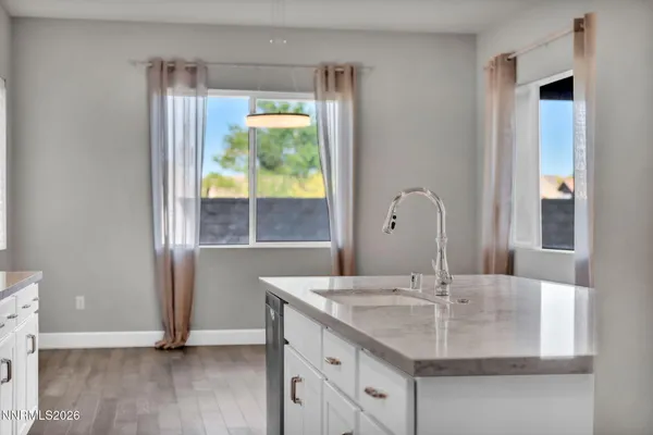 a spacious bathroom with a granite countertop sink a mirror and a shower