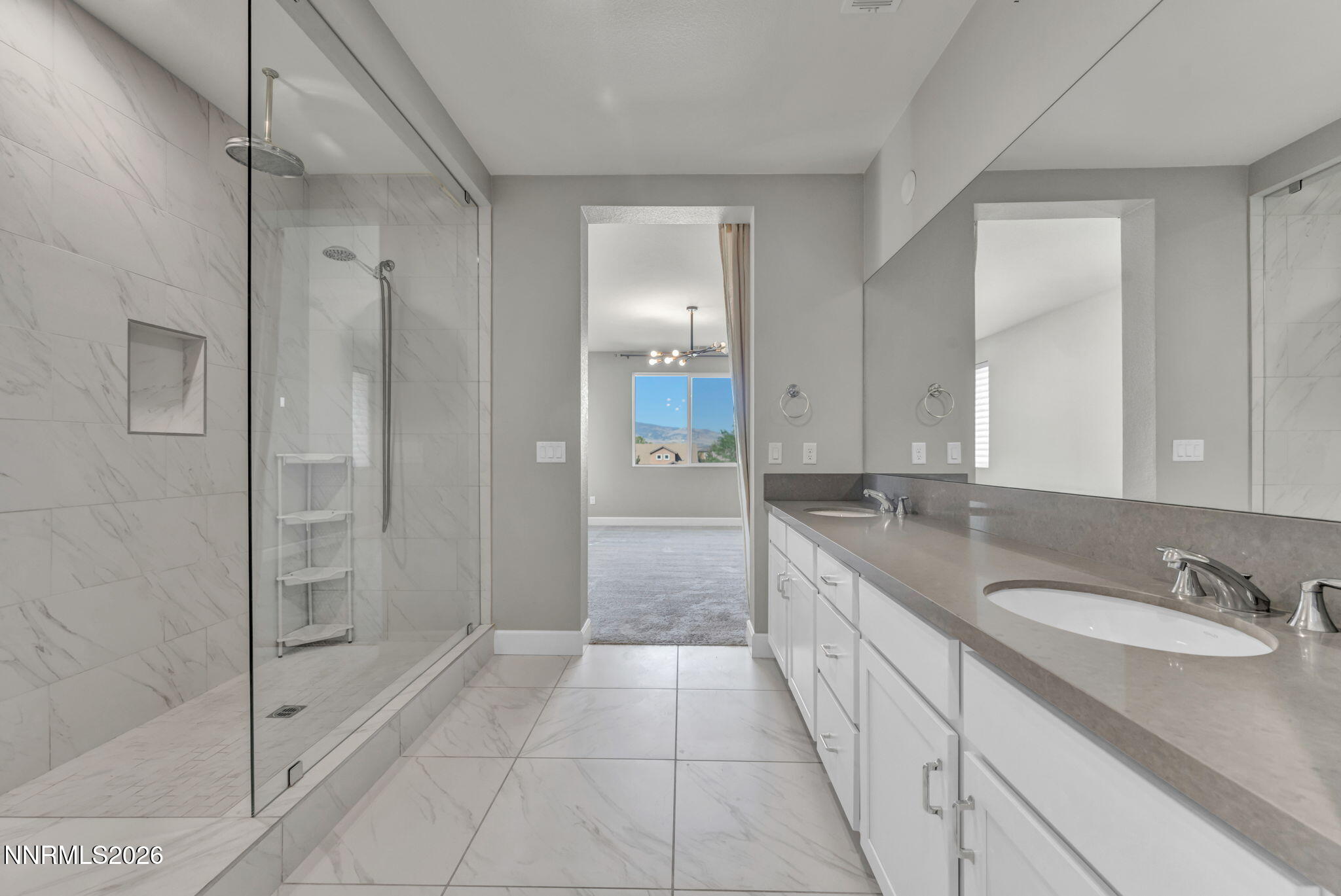 9267 Blue Basin Trail Reno, NV 89521 - Photo 38 of 95 a spacious bathroom with a granite countertop sink a mirror and a shower
