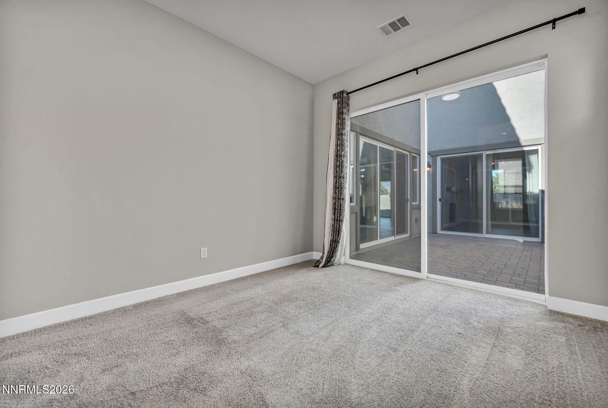 9267 Blue Basin Trail Reno, NV 89521 - Photo 45 of 95 a view of an empty room with glass door and a window