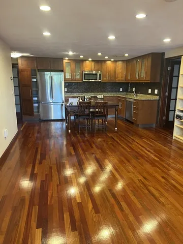 a kitchen with stainless steel appliances kitchen island granite countertop a sink and cabinets