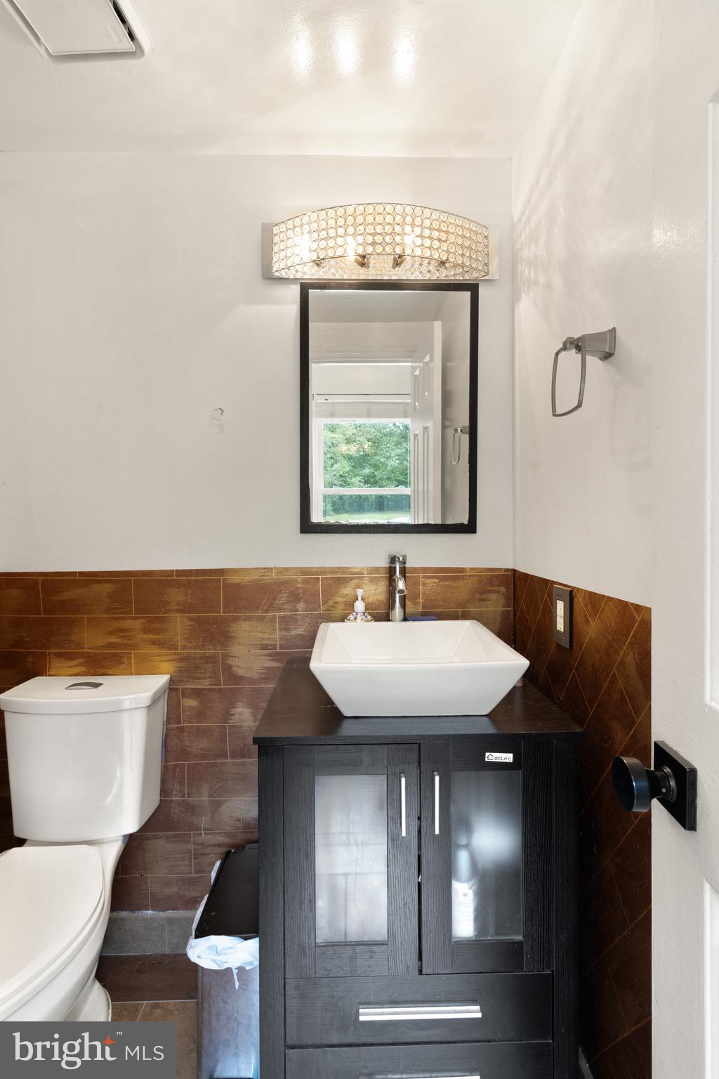 244 Raintree Boulevard Stafford, VA 22556 - Photo 13 of 34 a bathroom with a sink a toilet and a mirror