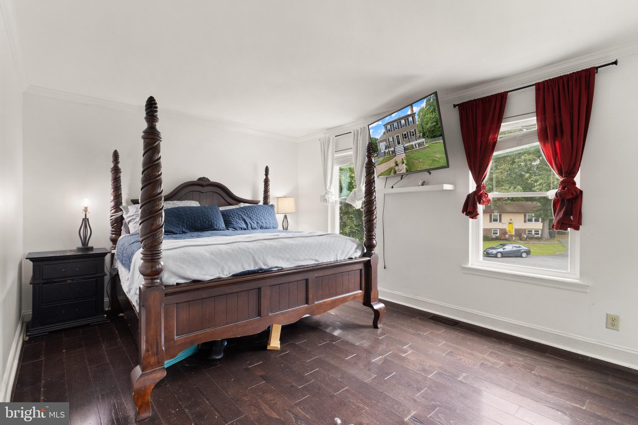 244 Raintree Boulevard Stafford, VA 22556 - Photo 14 of 34 a bedroom with a bed next to a window with outer view