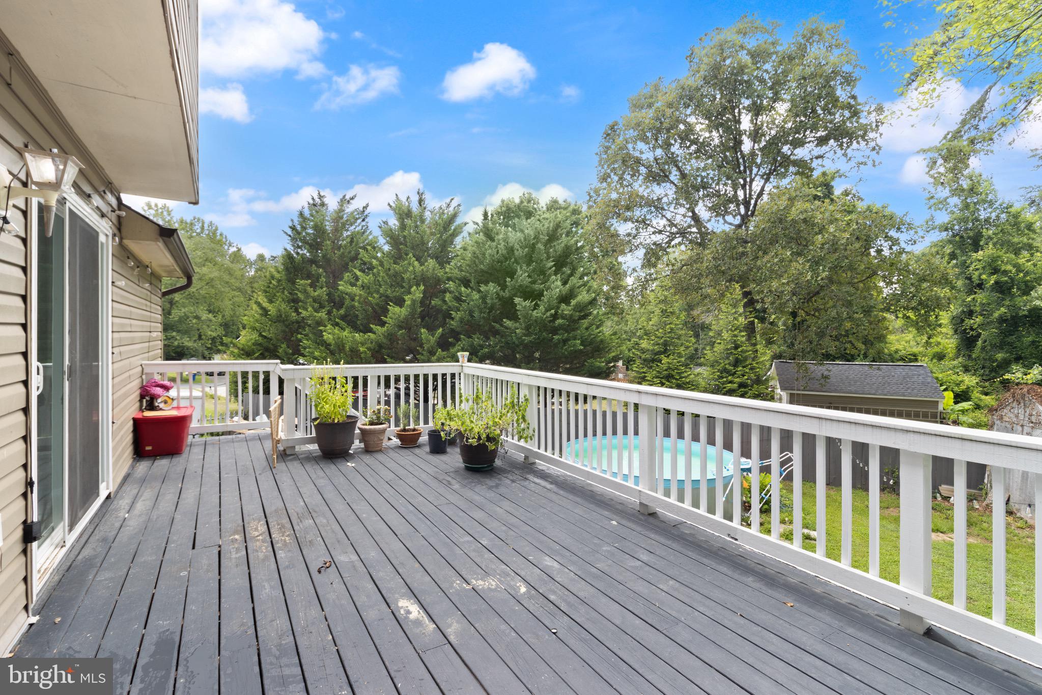 244 Raintree Boulevard Stafford, VA 22556 - Photo 31 of 34 a balcony with wooden floor and fence