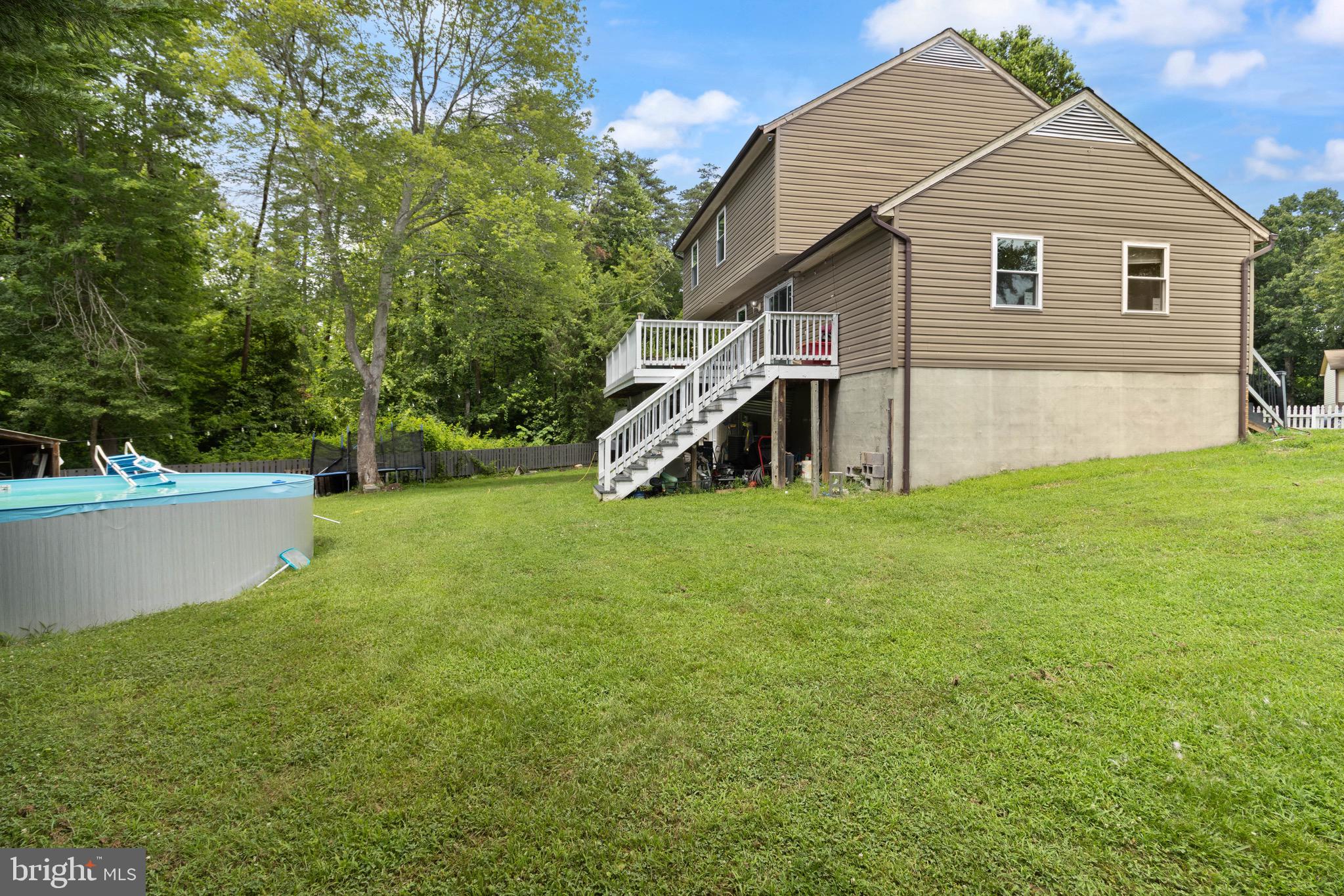 244 Raintree Boulevard Stafford, VA 22556 - Photo 33 of 34 a view of a house with a yard and sitting area