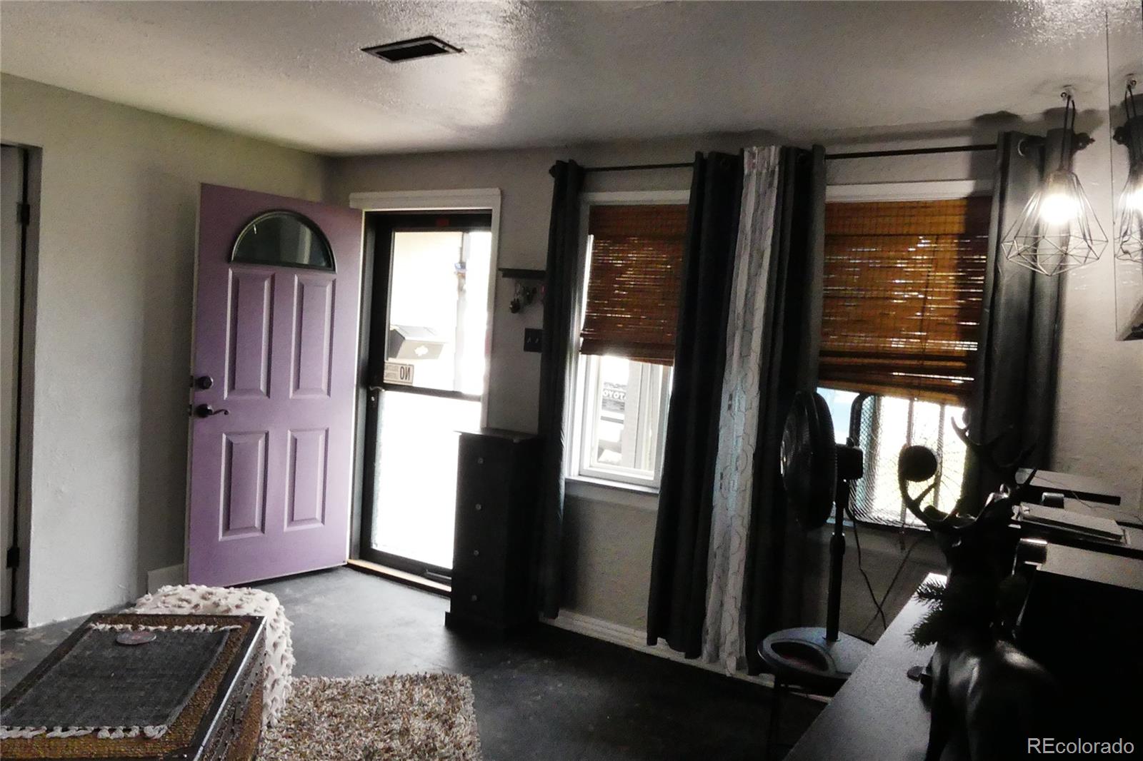 4851 Adams Street Denver, CO 80216 - Photo 12 of 30 a view of hallway with furniture and a window